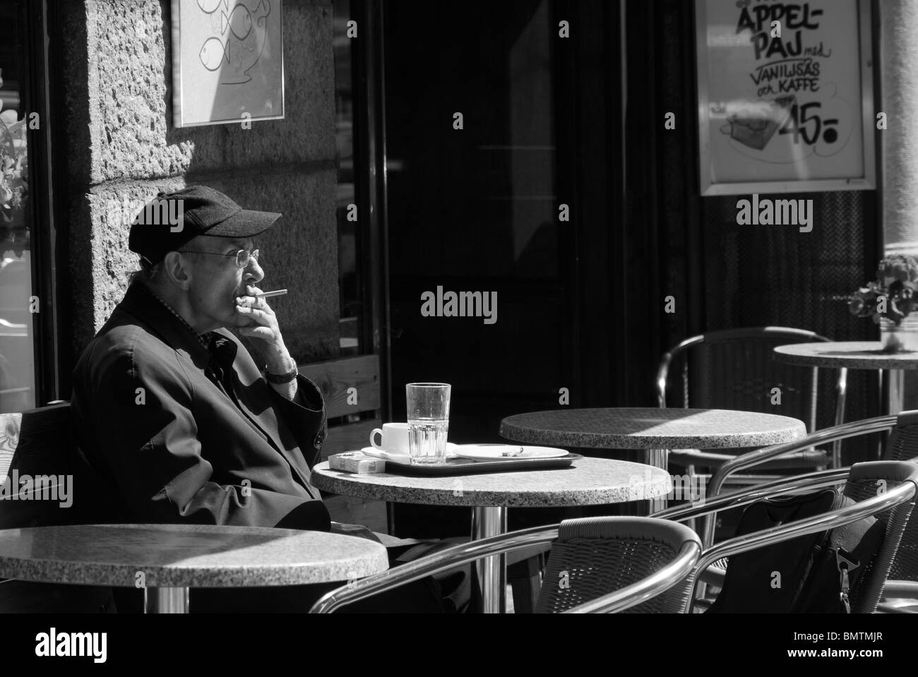 Man smoking at a cafe in Kungsgatan Stockholm, Sweden Stock Photo