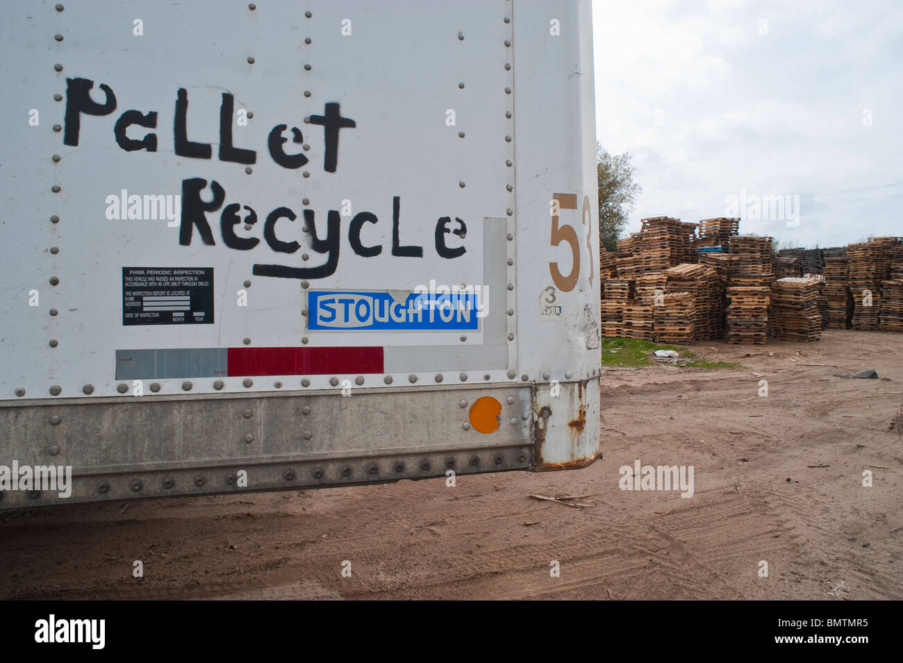 "Pallet Recycle" written on the side of a semi trailer at a pallet