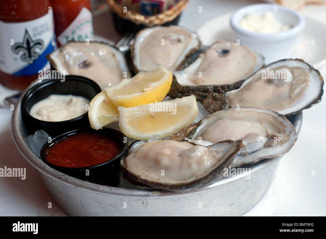 A serving of half a dozen fresh oysters from Dickie Brennan's Bourbon House, a famous restaurant in New Orleans, Louisiana, United States. Stock Photo