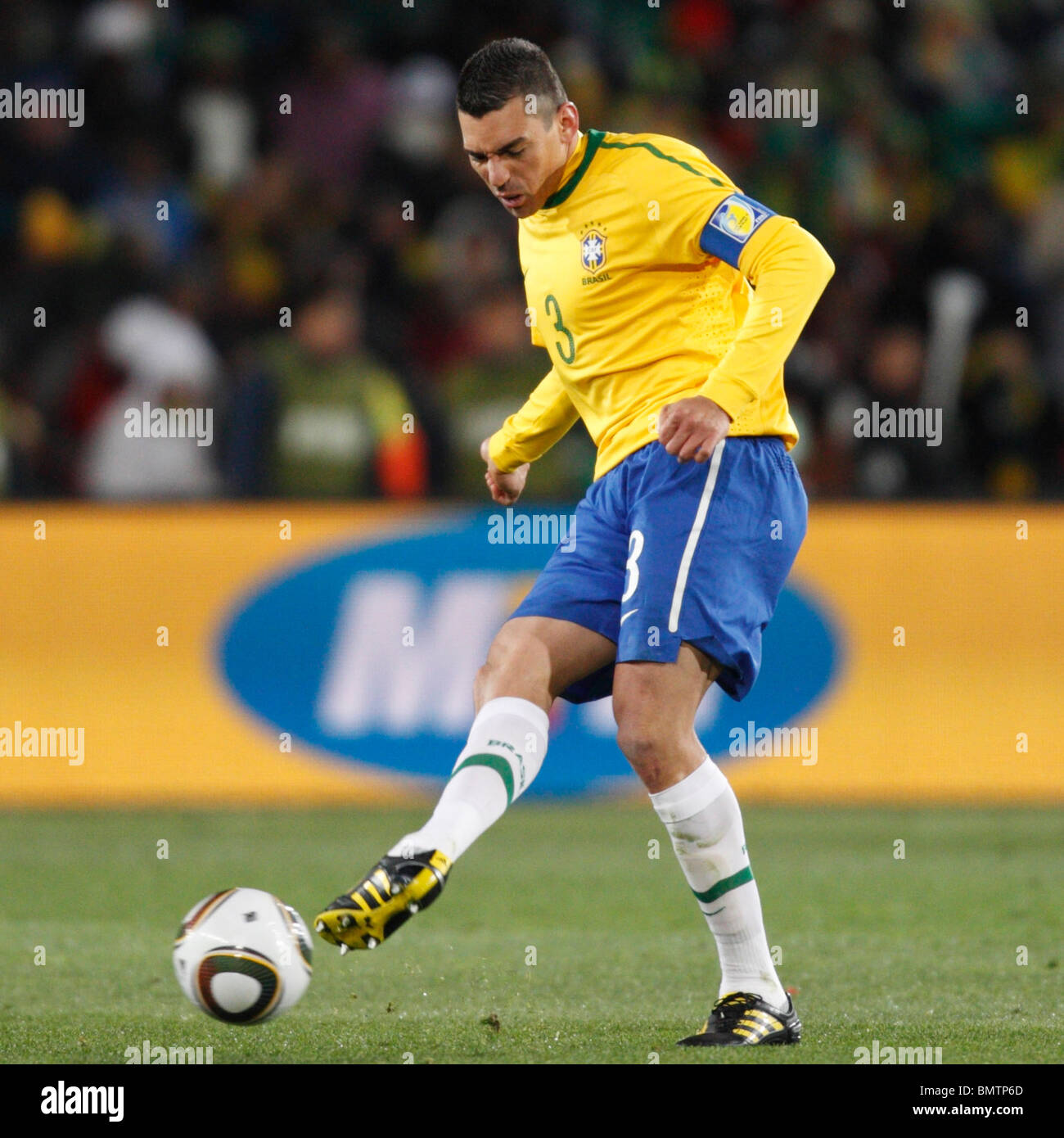 Brazil team captain Lucio passes the ball during a 2010 FIFA World Cup football match against North Korea. Stock Photo