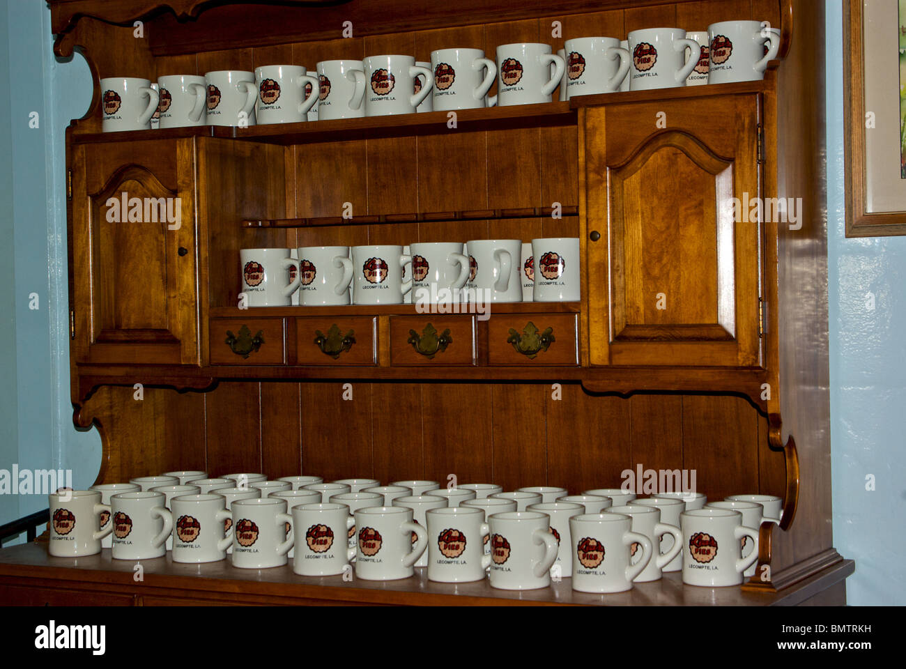 Souvenir porcelain coffee mugs for sale on big wooden hutch Lea's Pies Lunchroom diner in Compte