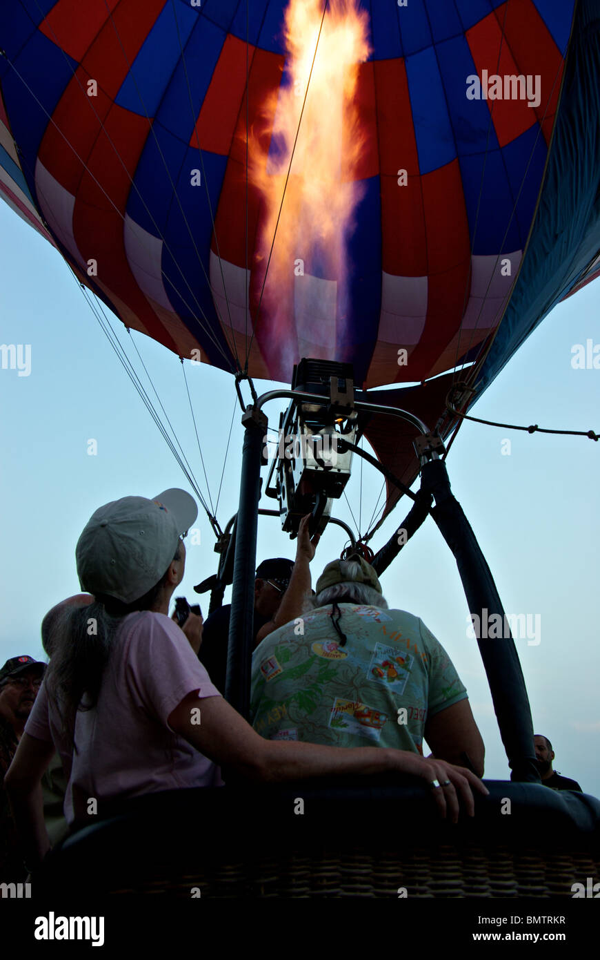 American Escapes Aerosports hot air balloon owner giving propane burners a fiery hot blast for lift Shreveport Bossier LA Stock Photo