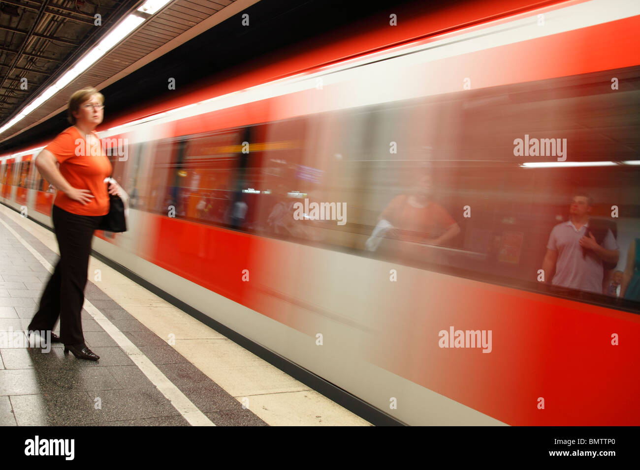 woman on platform of S-Bahn station Stock Photo