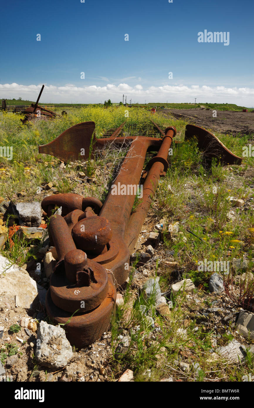 Rusty old anchor used as a railway buffer stop. Stock Photo