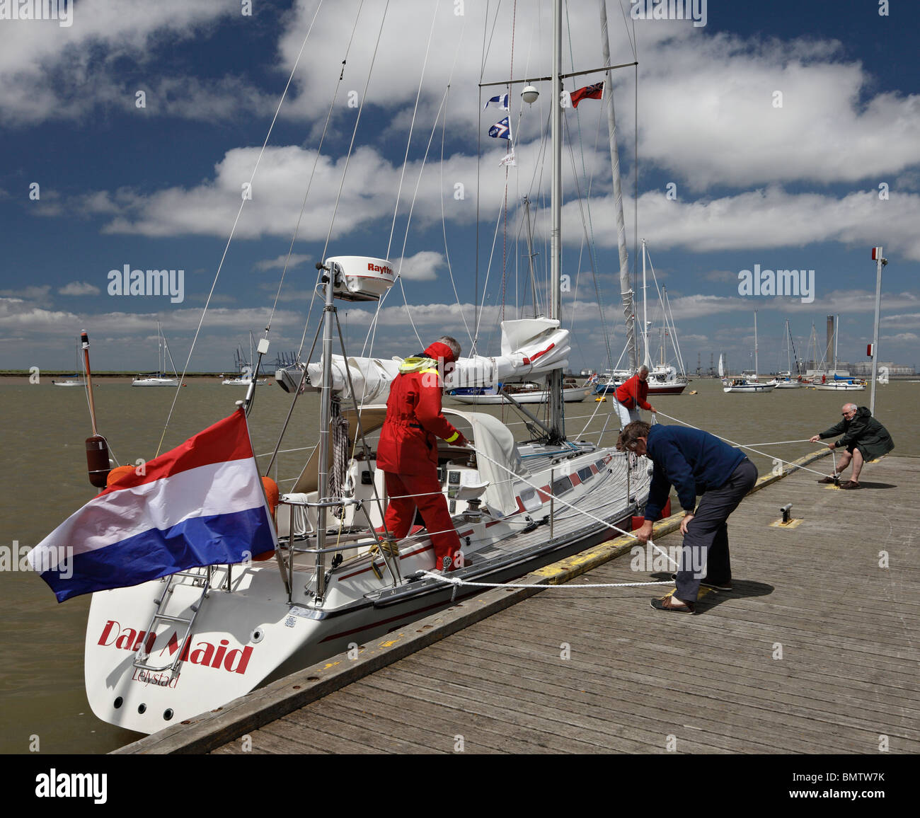 Sailing boat being pulled into a mooring. Stock Photo
