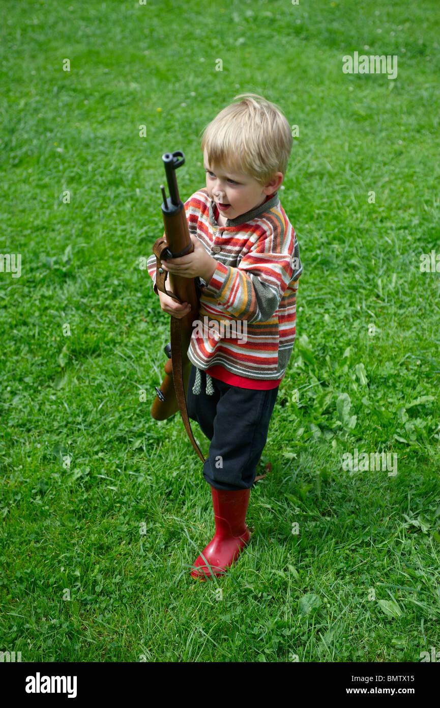 Child blond boy playing with air gun Stock Photo Alamy