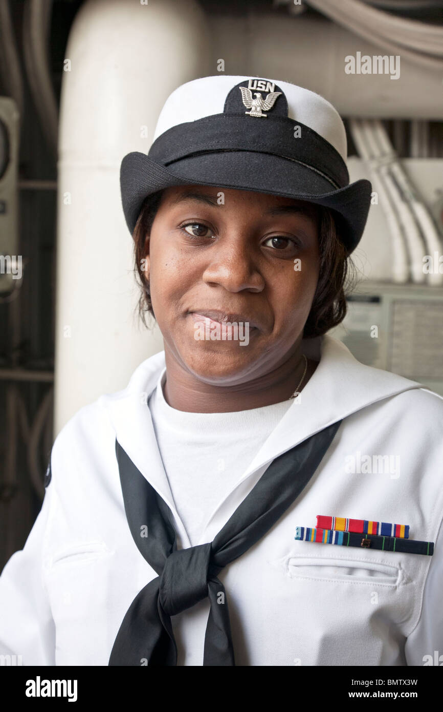 winsome young woman sailor on duty as Messenger of the Watch on USS Iwo Jima during fleet week in Manhattan New York City Stock Photo