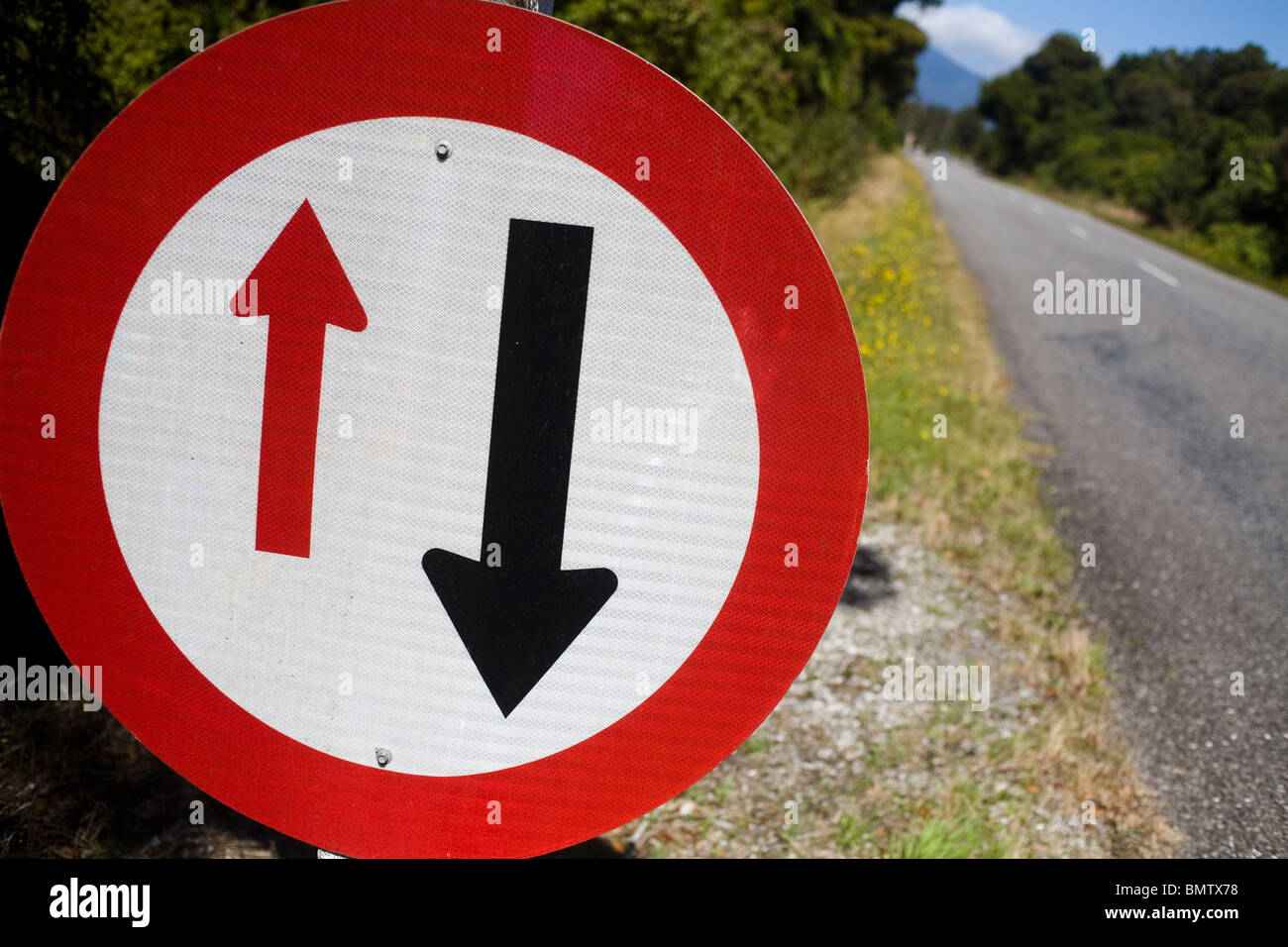 Give priority to oncoming traffic road sign. Stock Photo