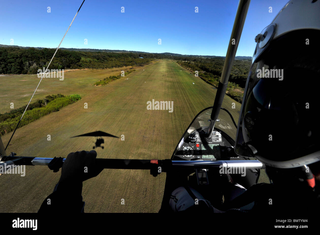 A microlight aircraft approaches a runway Stock Photo - Alamy