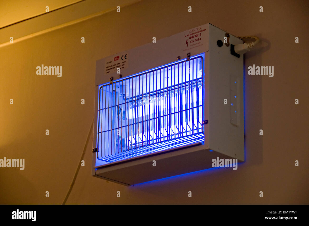 an electric fly trap in a restaurant cafe to keep bugs down Stock Photo