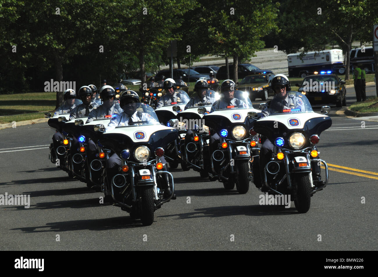 hundreds of police motorcycles escort the hearse containing the body of a Md State Trooper who was gunned down last week Stock Photo