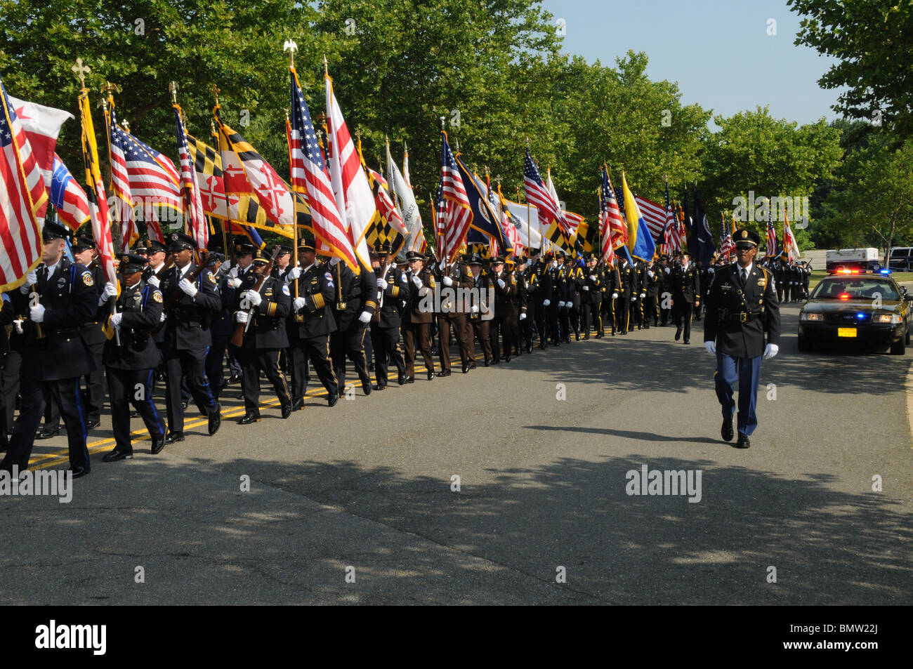 Hundreds of police honor guards from all over the USA march down the street at the funeral of a state trooper gunned down Stock Photo