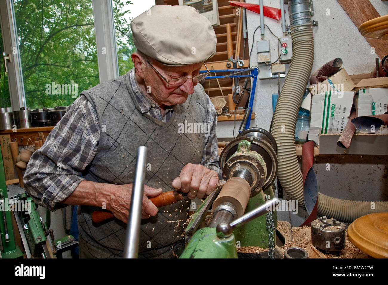 Master Woodturning man working on lathe with chisel turning and