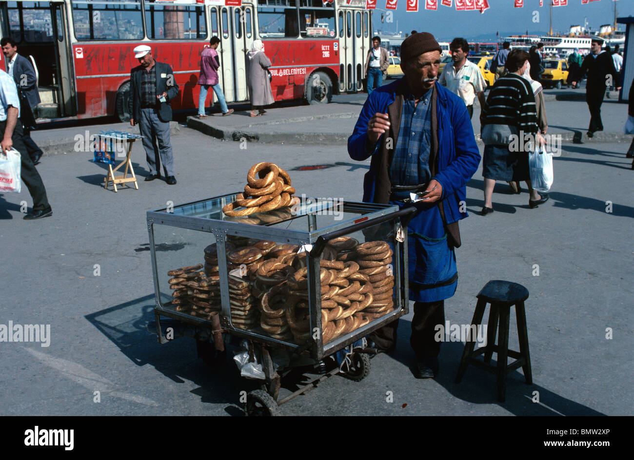 Simit Seller, Street Hawker or Vendor Selling Rolls of Sesame Bread, known as Simit, Beyazit, Istanbul, Turkey Stock Photo
