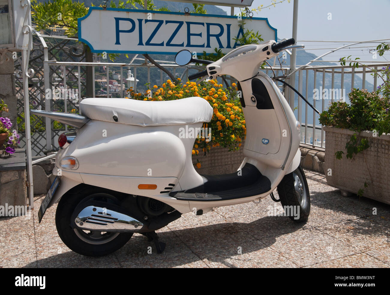 Pizzeria sign and a Piaggio Vespa ET4 150 in Positano on the Amalfi Coast, Italy Stock Photo