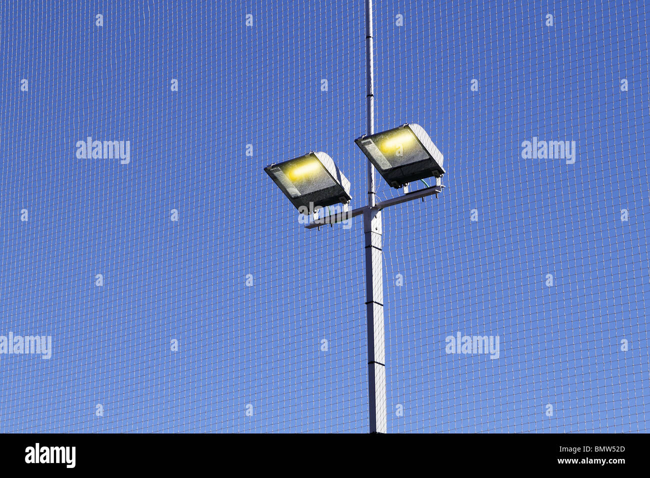 sport field lighting equipment spots light blue sky Stock Photo