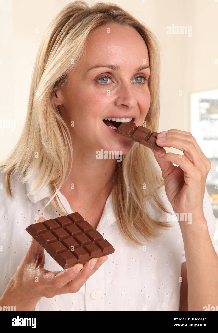 WOMAN EATING CHOCOLATE Stock Photo