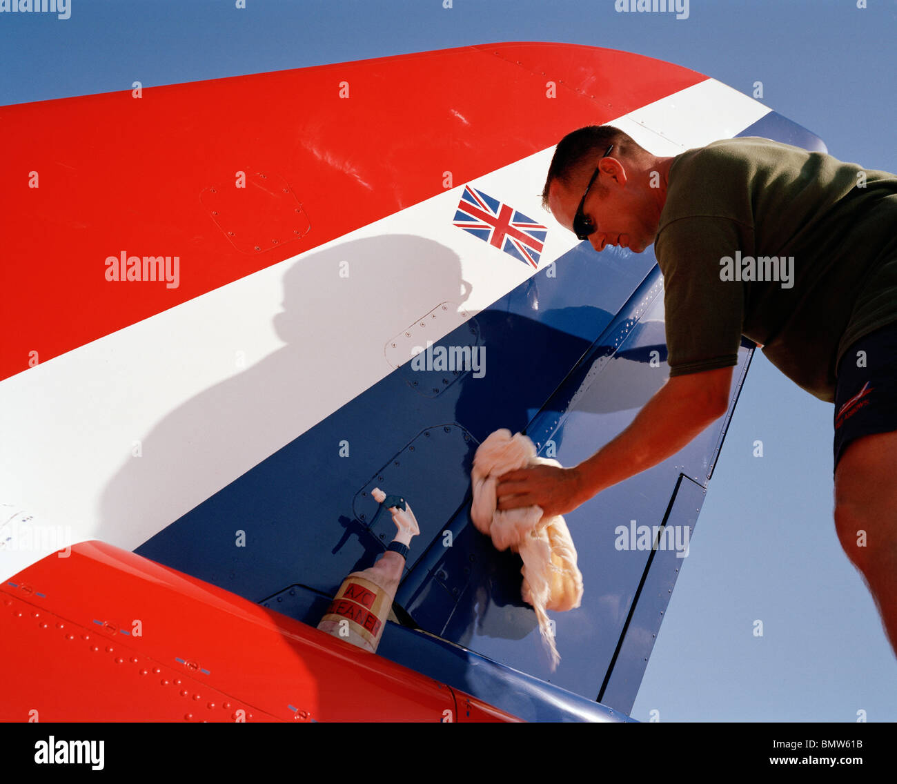 Engineer polishing Red Arrows aerobatic jet aircraft's flying surfaces ...
