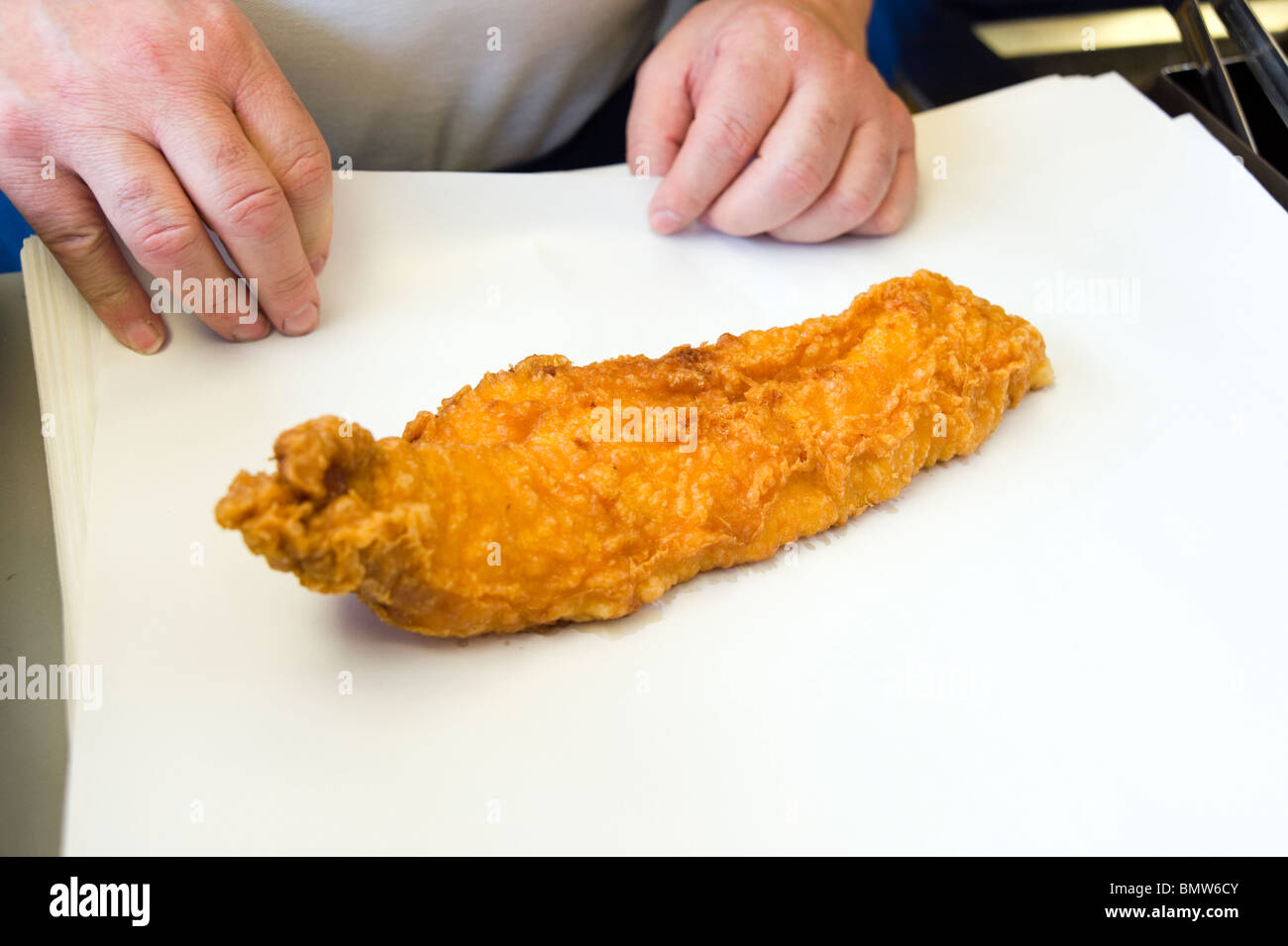Portion of battered cod at fish and chip shop, England, UK Stock Photo