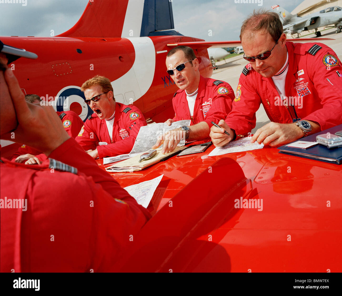 Pilots the 'Red Arrows', Britain's Royal Air Force aerobatic team during  pre-flight briefing 'on the wing' before display Stock Photo - Alamy