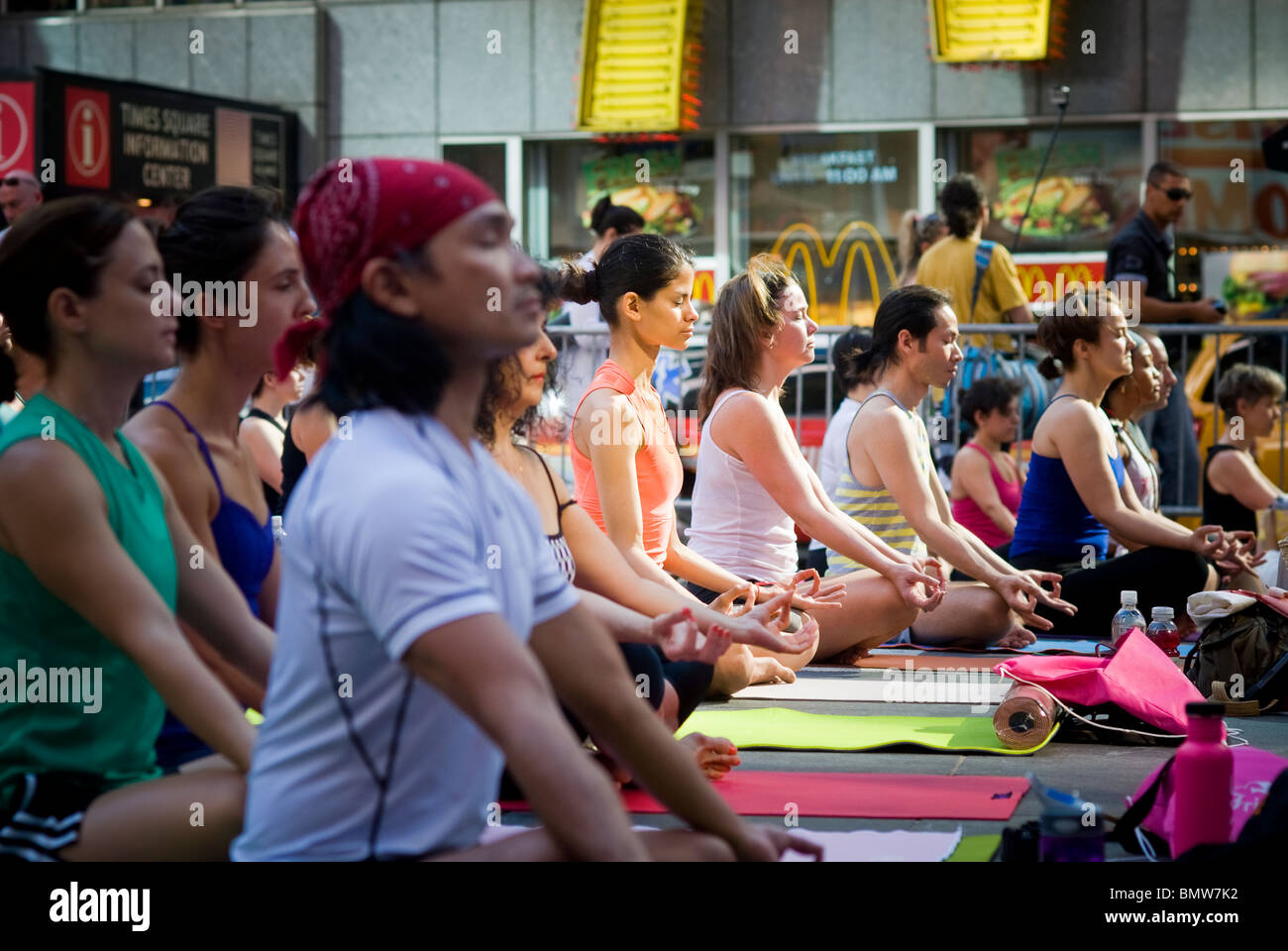 Yoga practitioners in Times Square in NY participate in one of the free yoga classes observing the Summer Solstice at 7:28AM Stock Photo