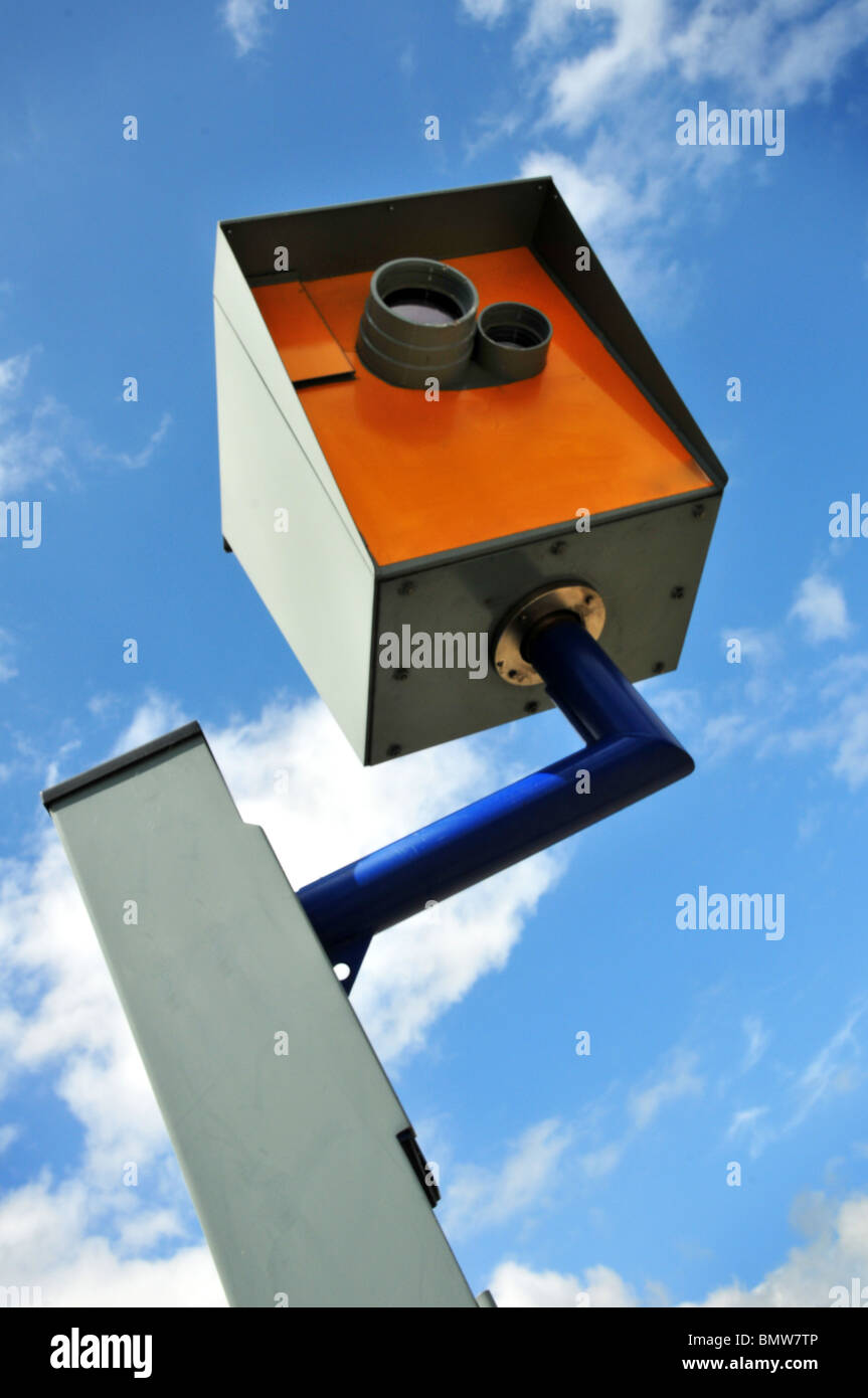Seen from below a speed camera with sky and clouds behind Stock Photo