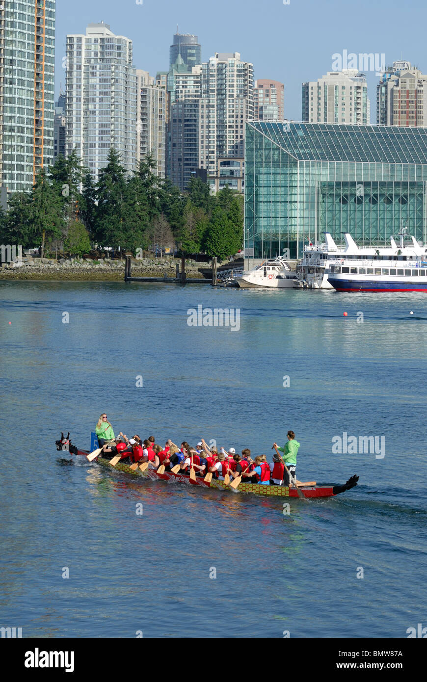 Dragon Boat Team paddling in the waters of false Creek, with the downtown City of Vancouver in the background. Stock Photo