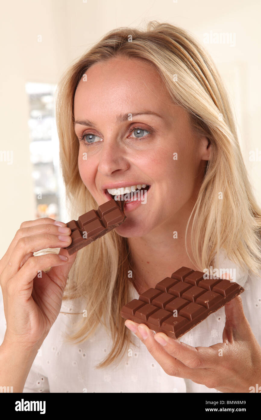 WOMAN EATING CHOCOLATE Stock Photo