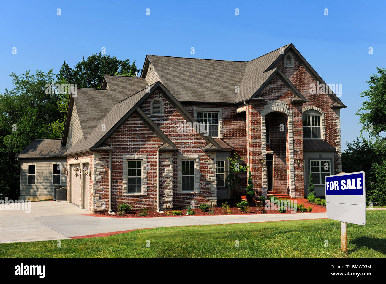 New house for sale with sign on front yard Stock Photo Alamy