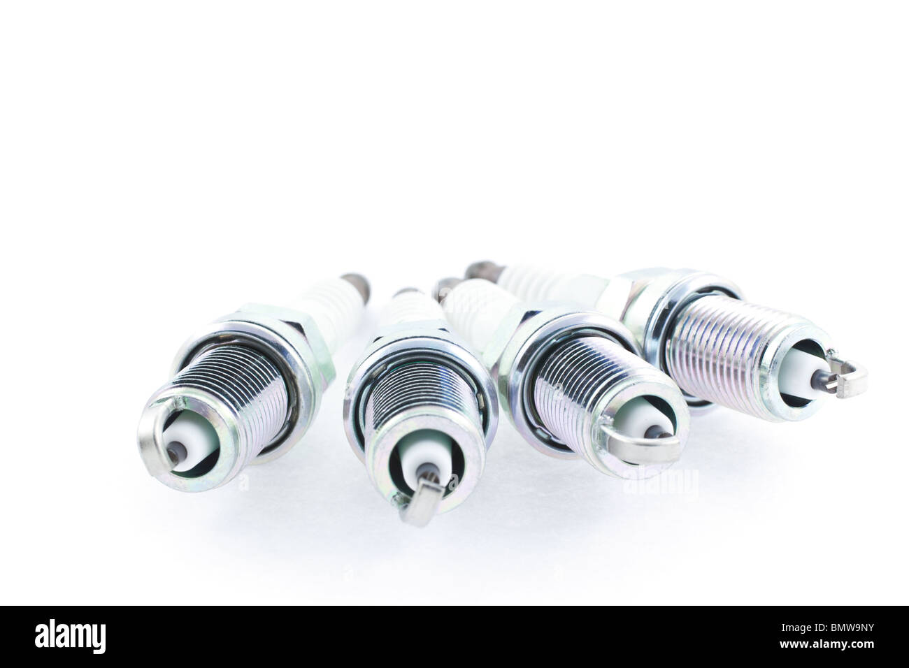 Four Spark Plugs on a white background. horizontal shot Stock Photo Alamy