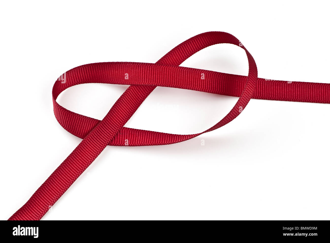 Red ribbon knotted in the shape of a heart Stock Photo