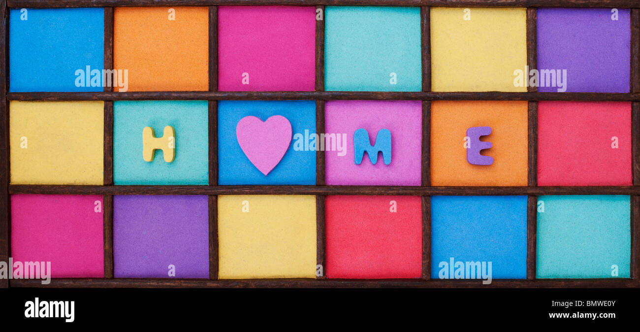 Multicoloured home and heart shape pattern in a wooden tray Stock Photo