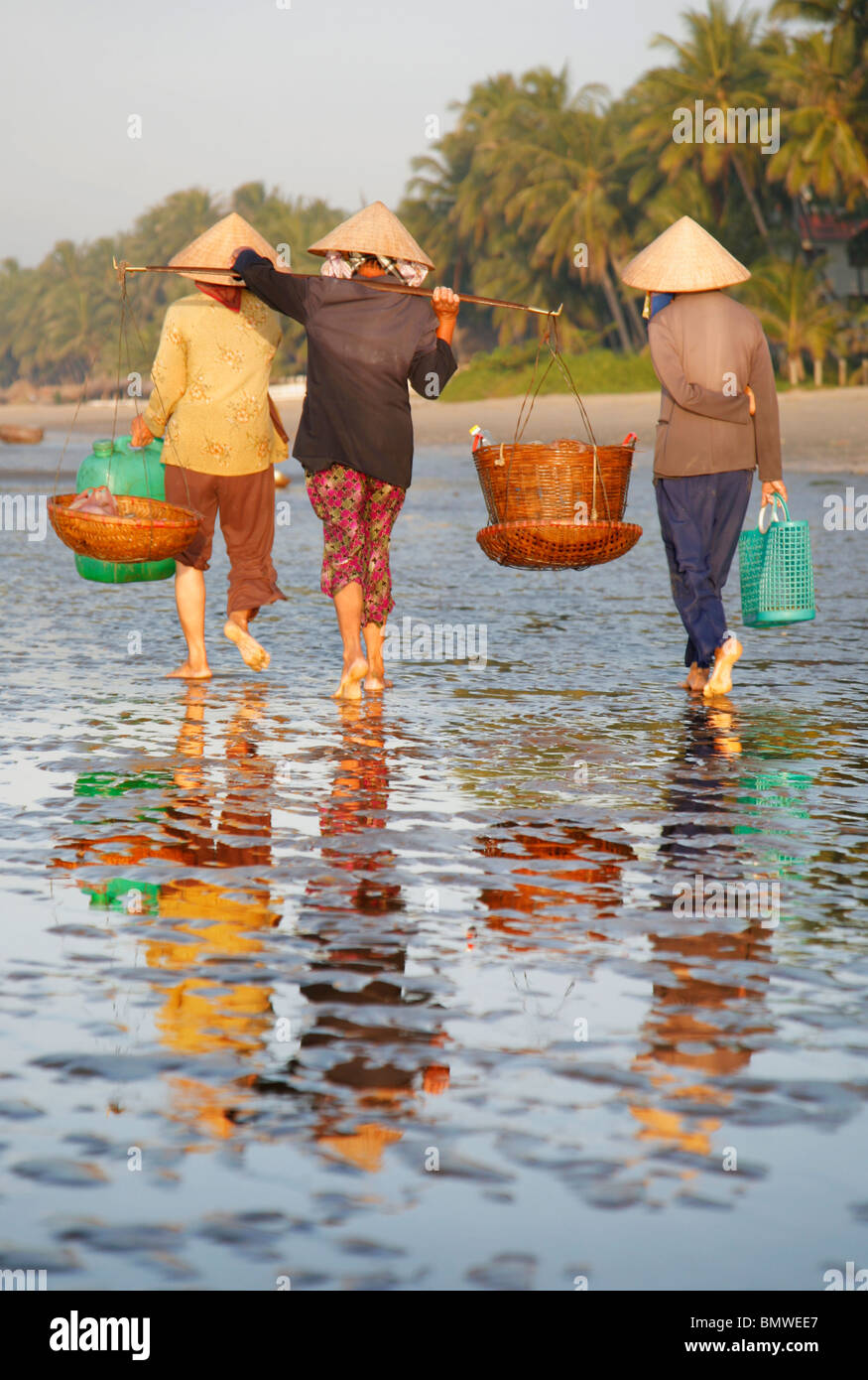 Three Vietnamese women on the beach at Mui Ne Stock Photo