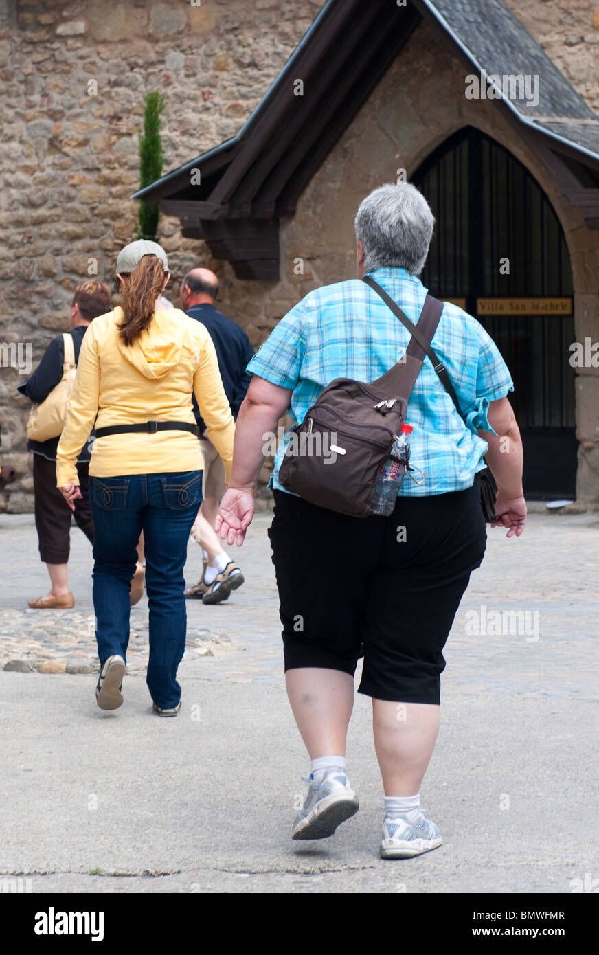 Overweight lady walking in France Stock Photo