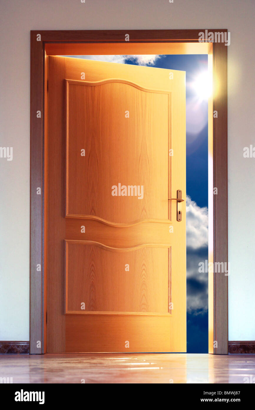 Opened door to blue sky with sun - conceptual image Stock Photo