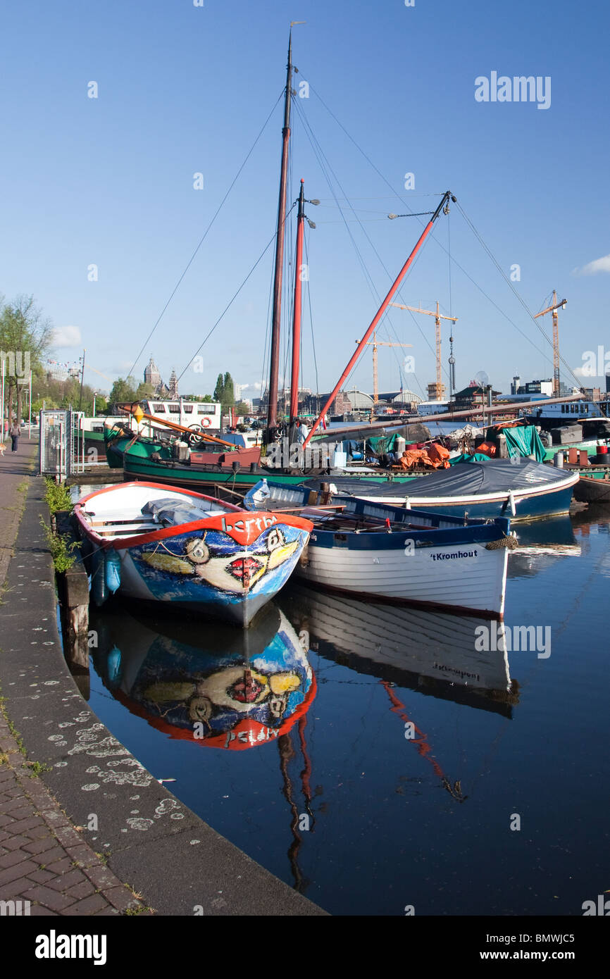 Three boats reflected in the water in the city of Amsterdam Stock Photo ...
