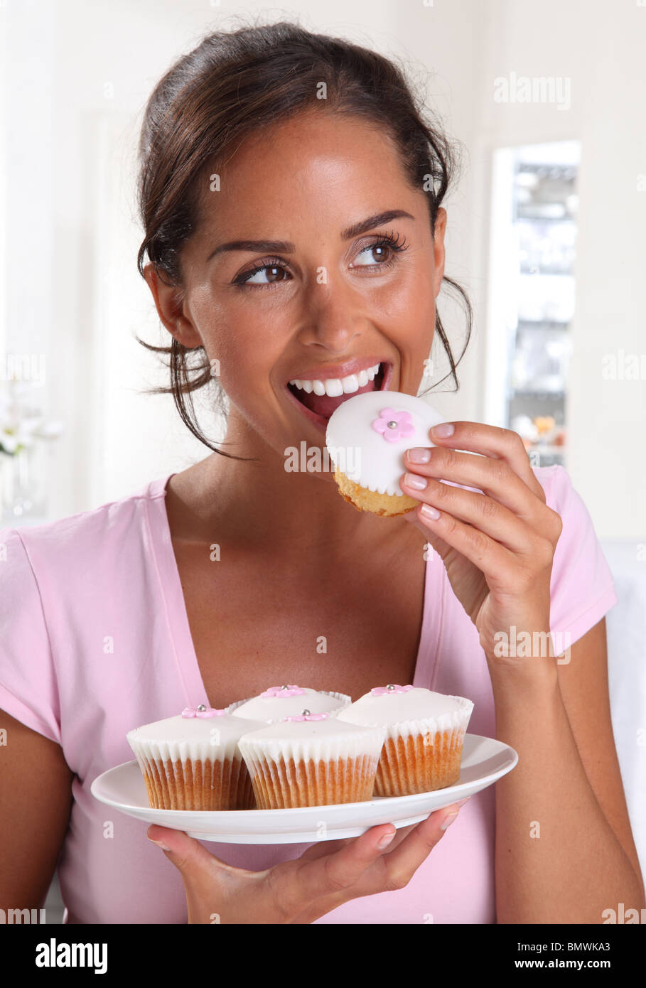 WOMAN EATING A CUPCAKES Stock Photo Alamy