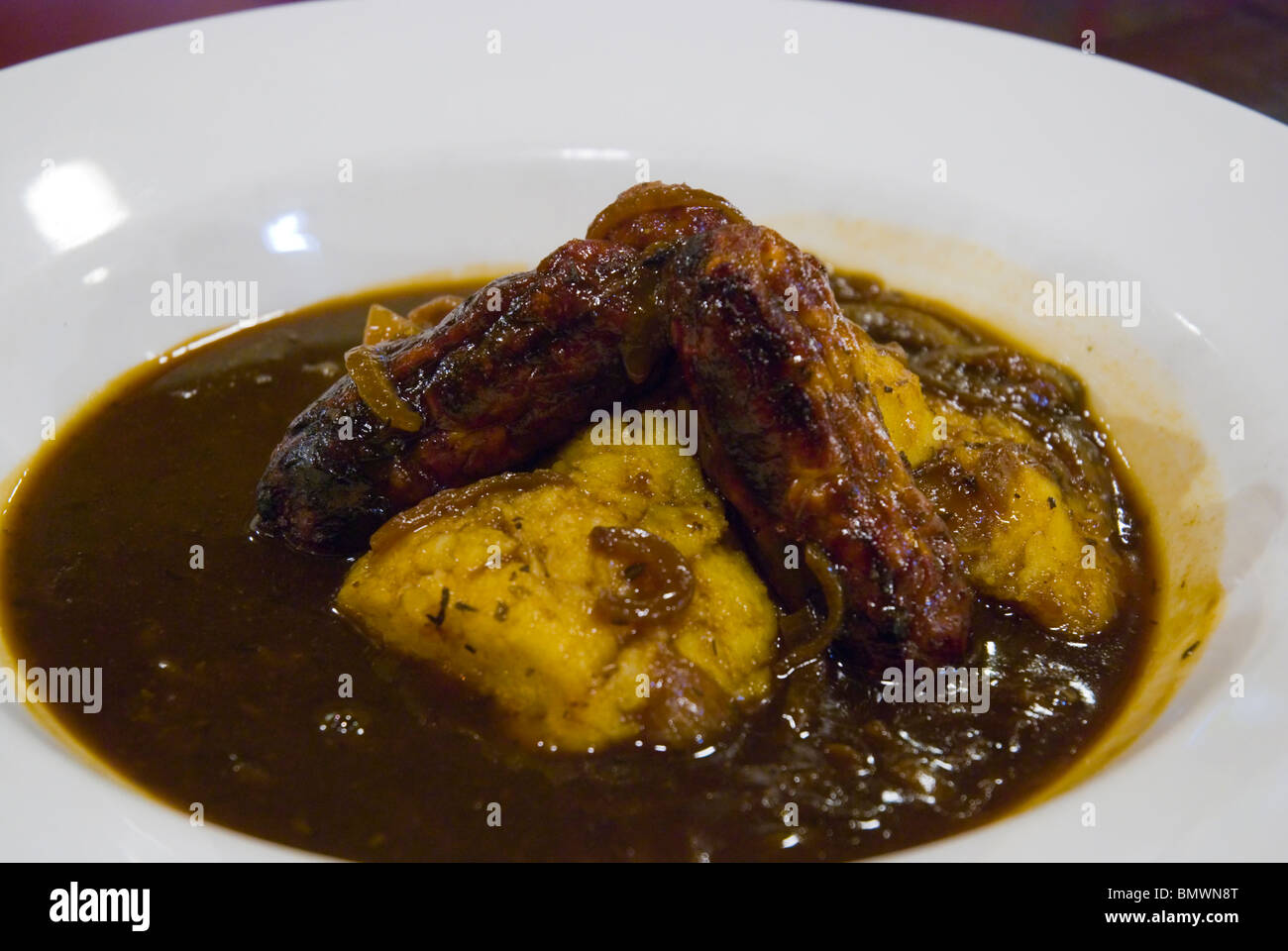 Bangers and Mash with gravy at a pub in London England UK Europe Stock