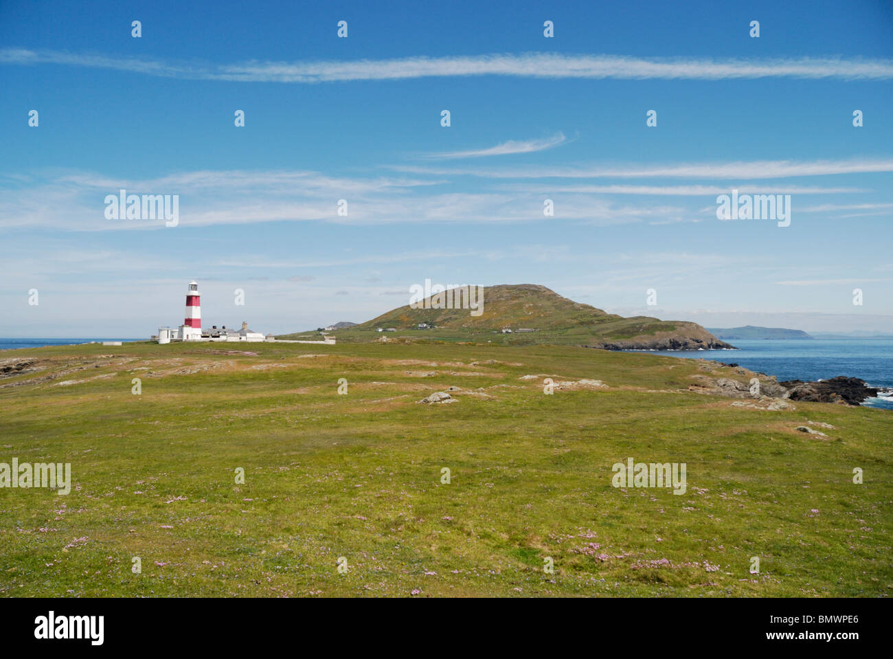 Lighthouse and Mynydd Enlli mountain on Bardsey Island, North Wales Stock Photo