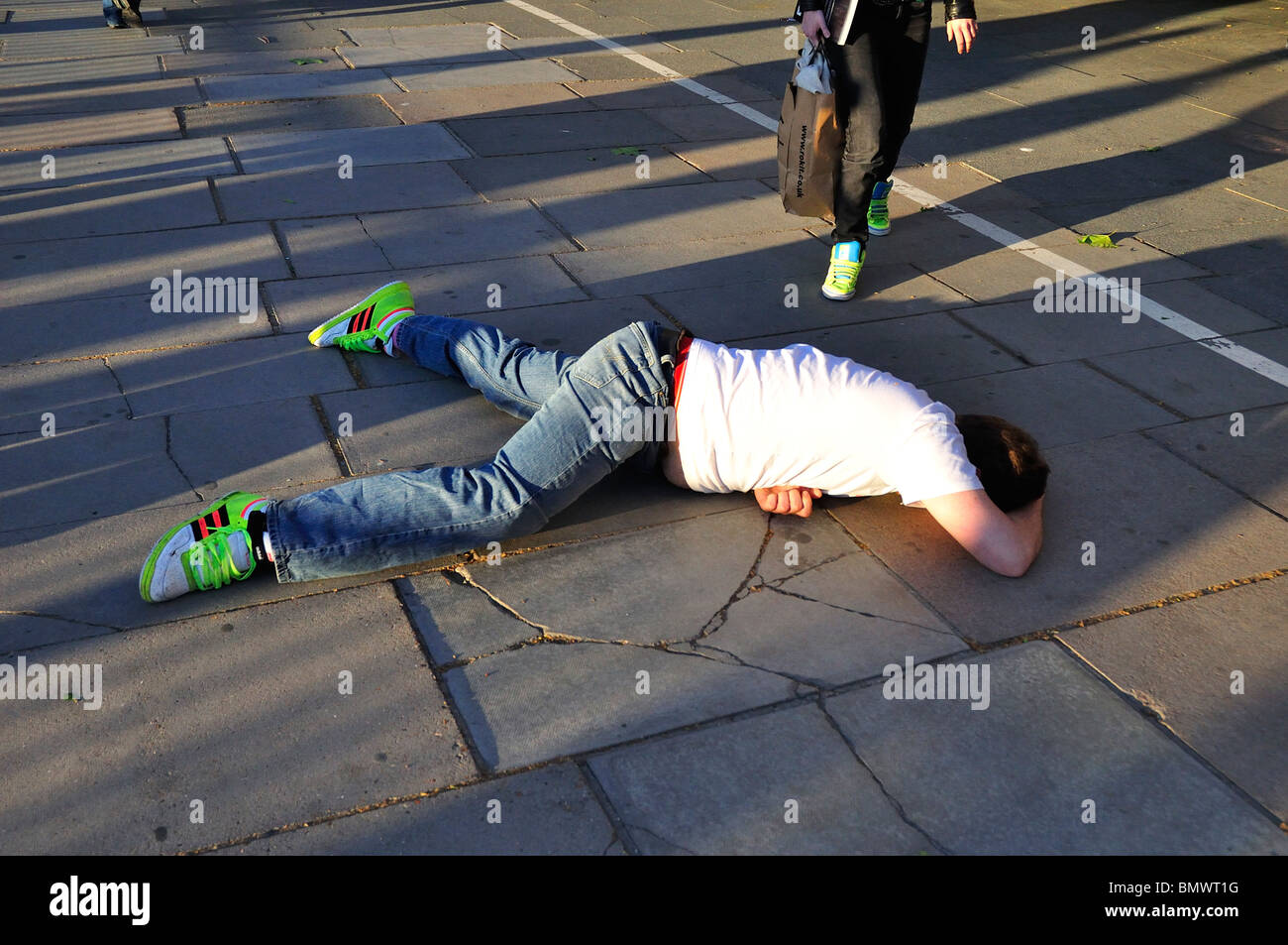 Drunk man Lying face down on pavement in London Stock Photo Alamy