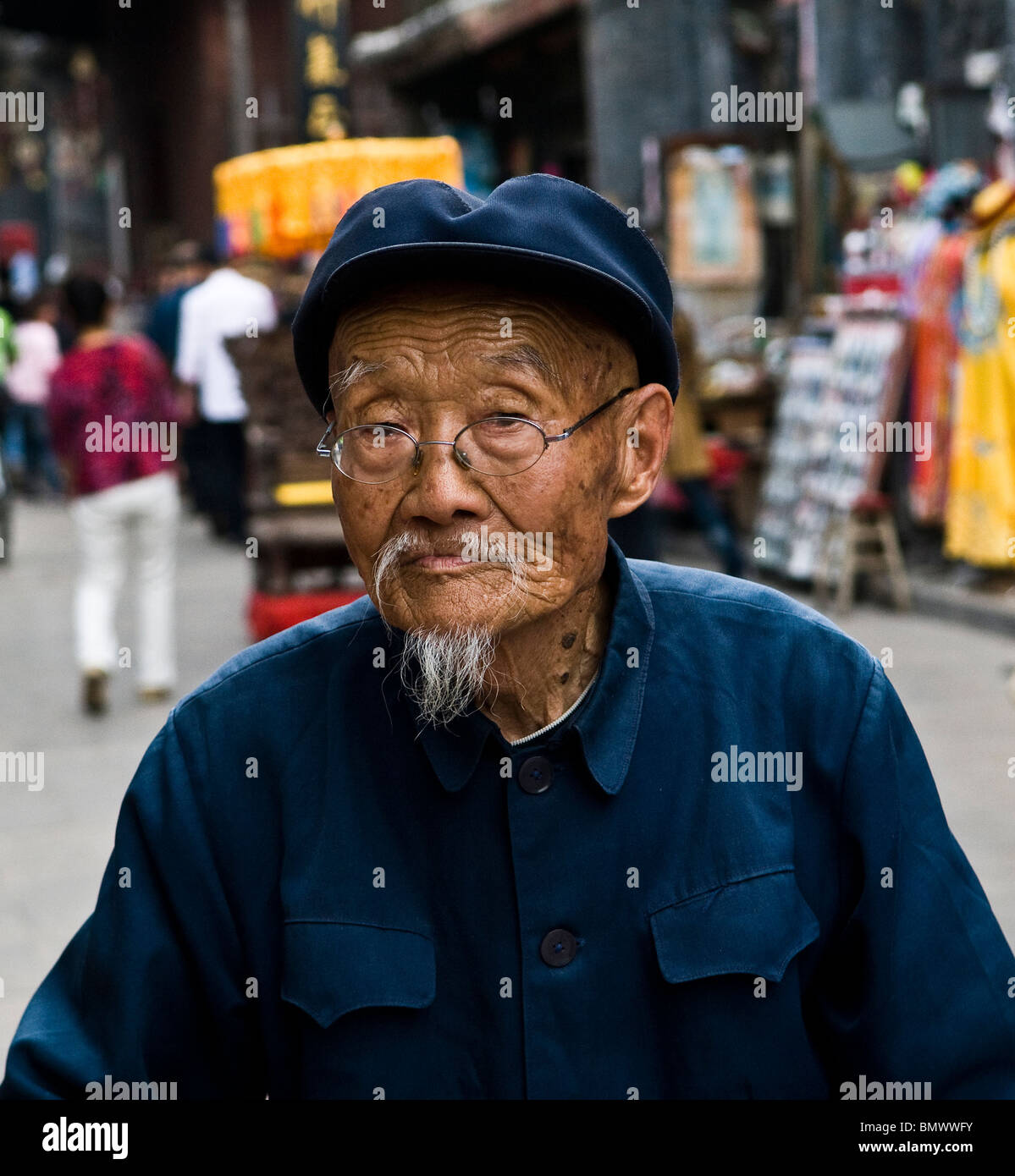 An old Chinese man waling in the old streets of Ping Yap, Shanxi, China. Stock Photo