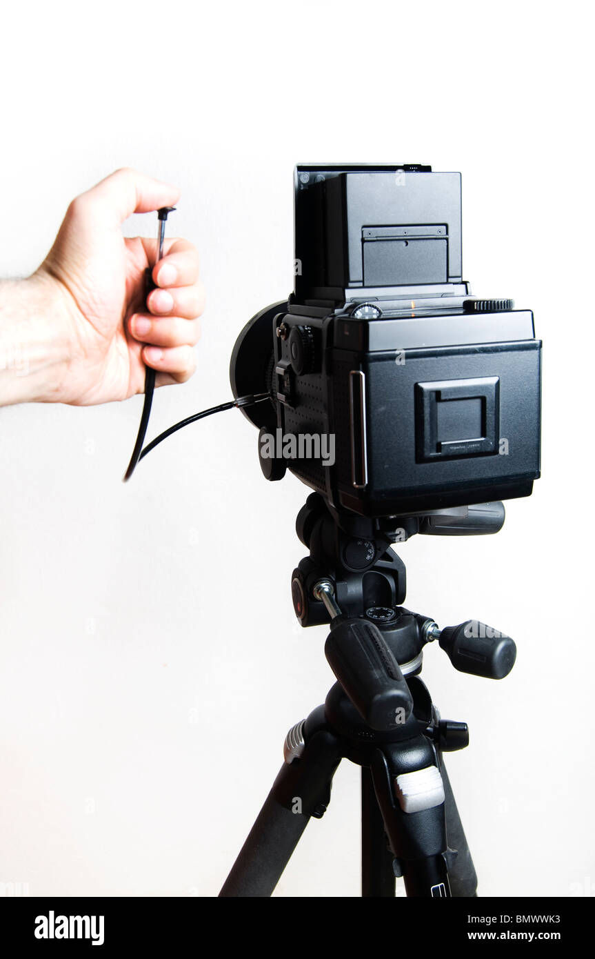 hand of photographer pushing the cable shutter on a Mamiya photo camera Stock Photo