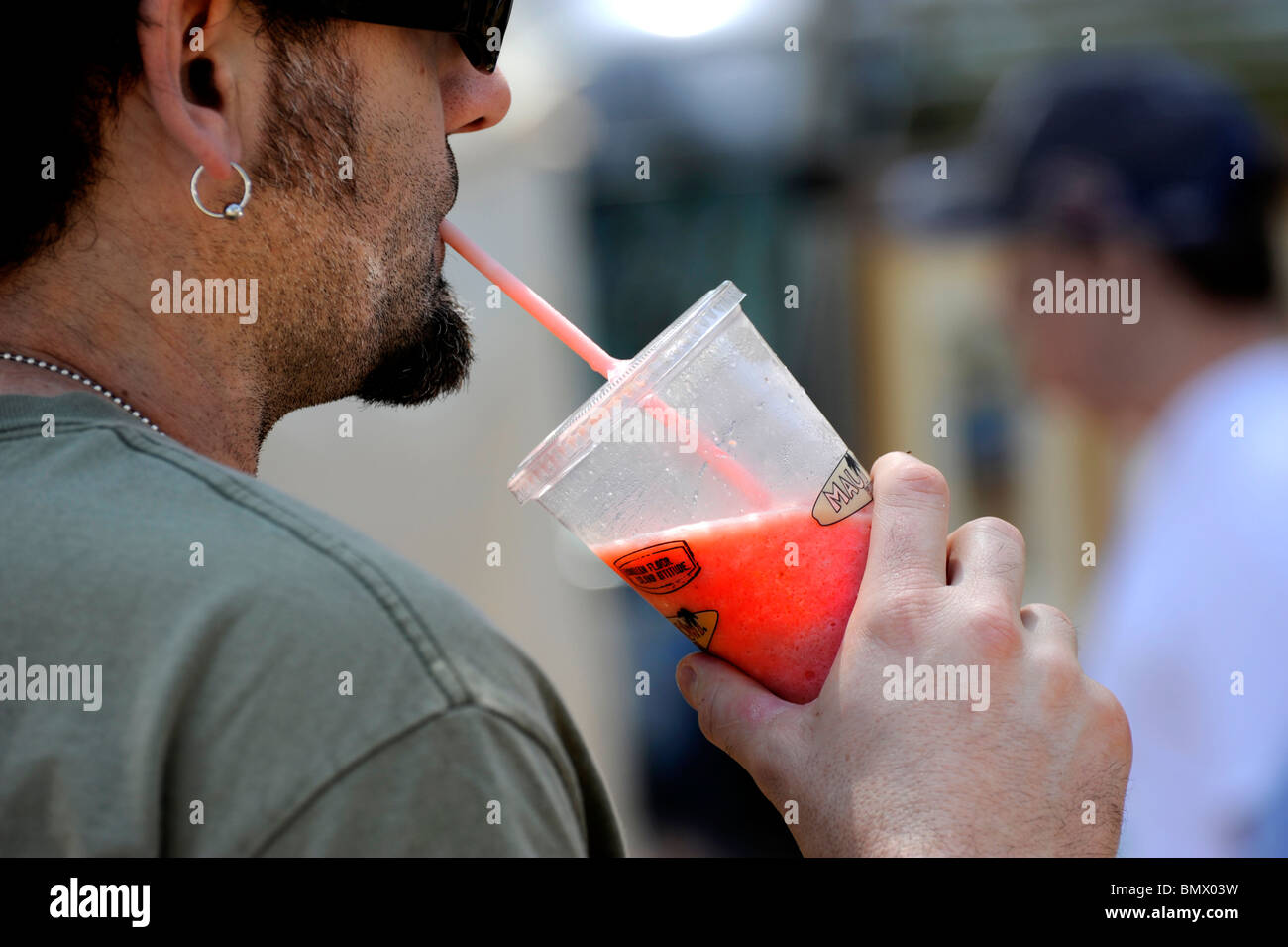 Man drinking beverage from plastic container Stock Photo - Alamy