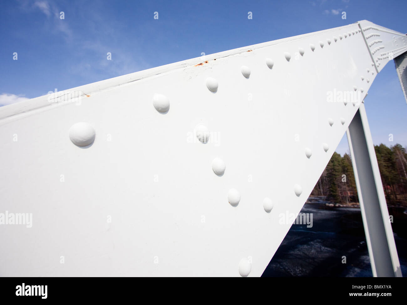 Metal beam constructed using rivets on iron bridge support structure Stock Photo