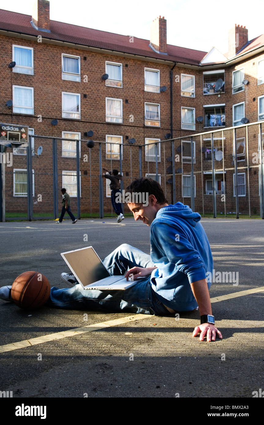 youth using laptop outdoors Stock Photo
