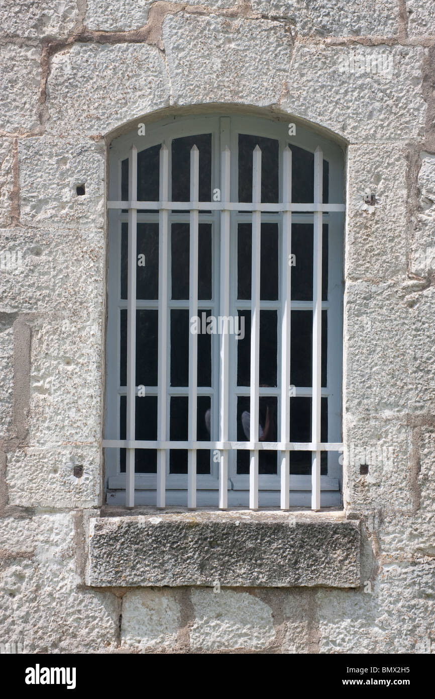 barred bars arch window stone wall Stock Photo