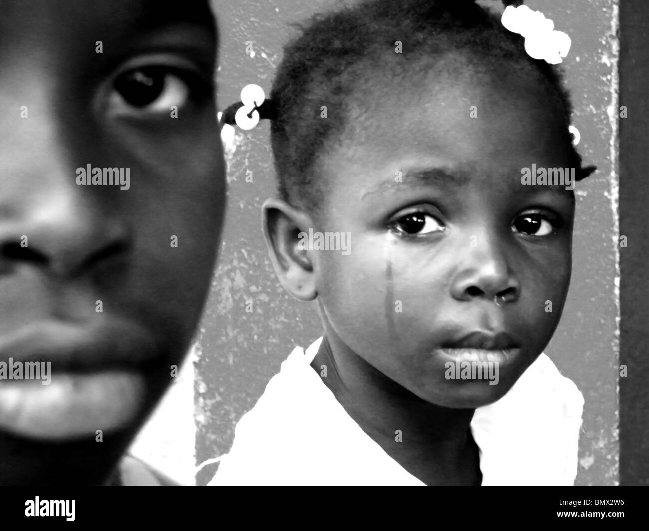 Haitian earthquake survivors cry at the Dominican Republic border after the Haiti earthquake in January Stock Photo