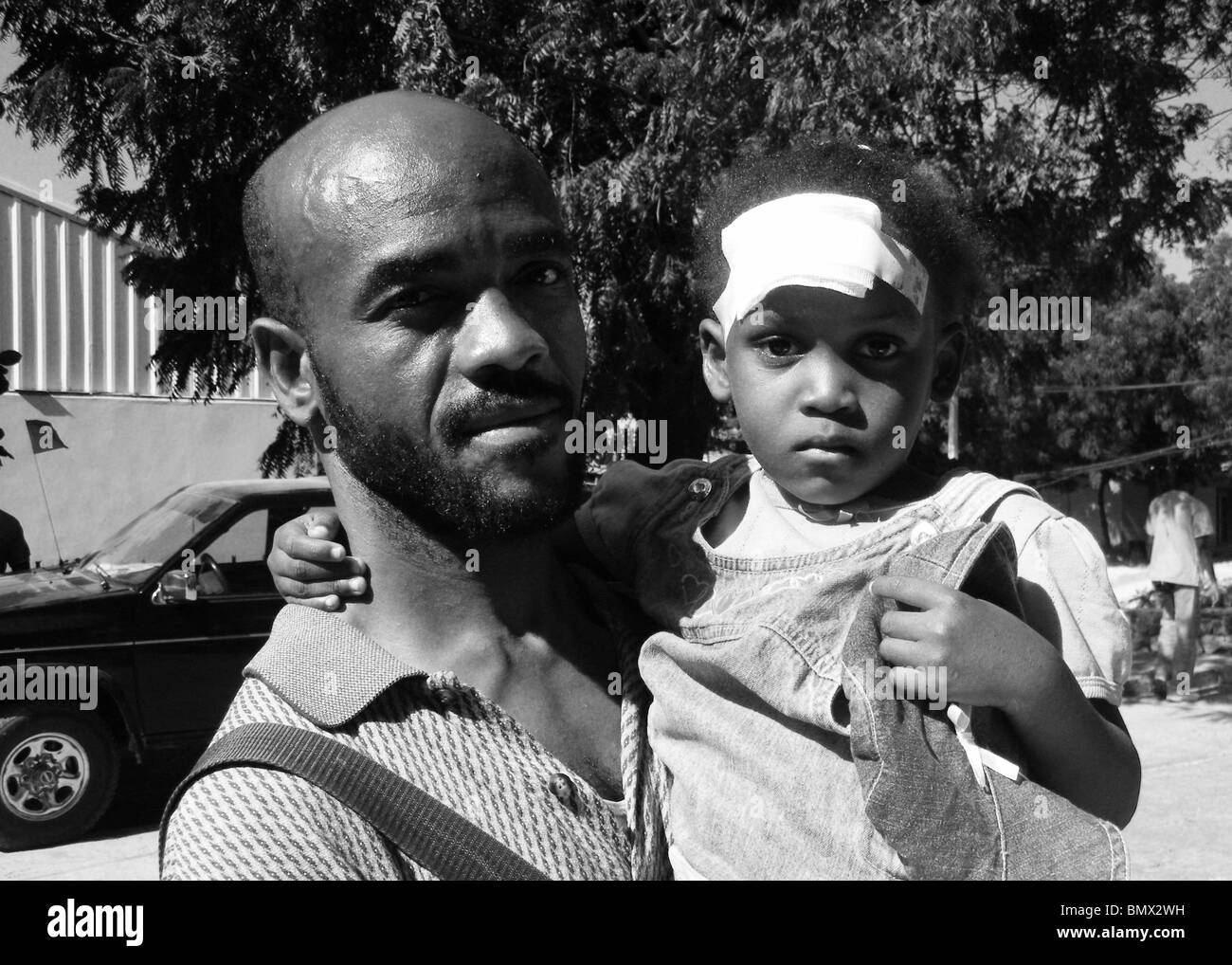 A man and hs injured daughter seek medical care in Port au Prince after the Haiti earthquake Stock Photo