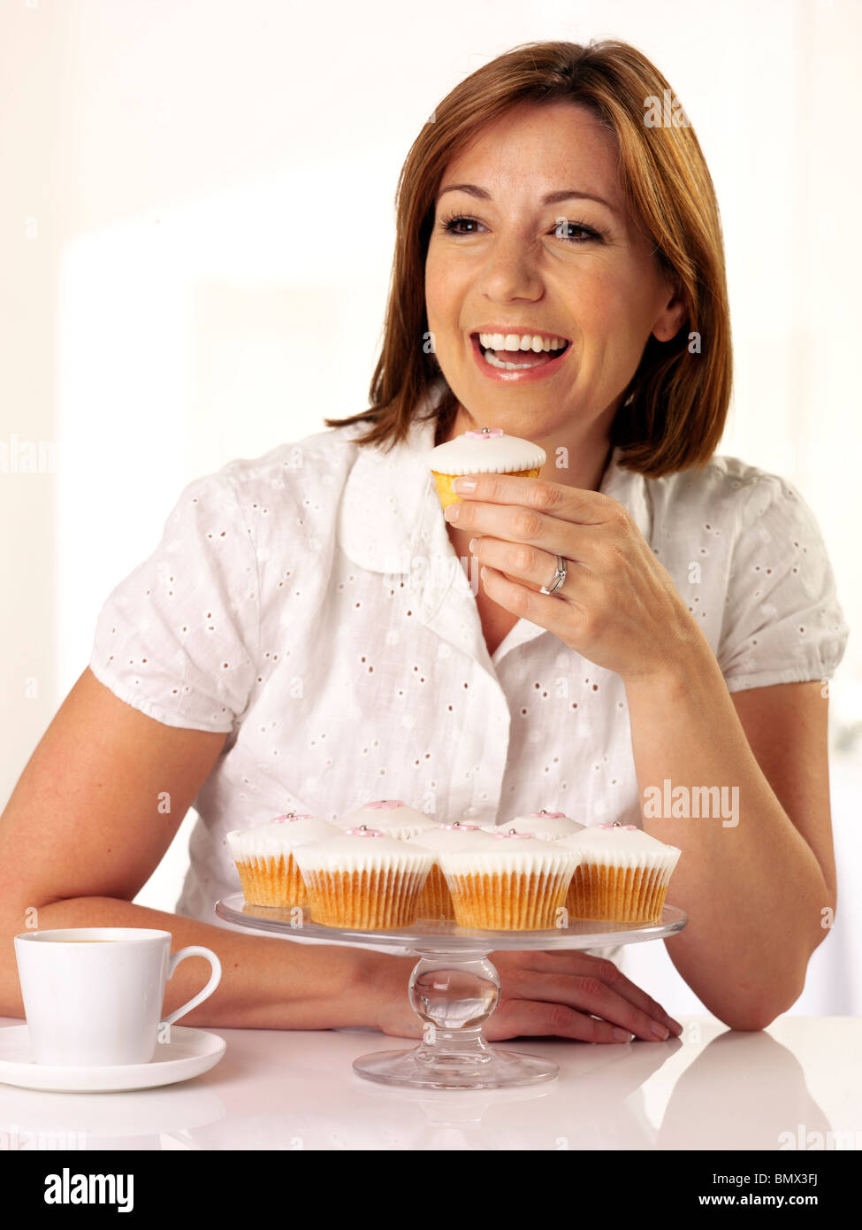 WOMAN EATING A CUPCAKE Stock Photo Alamy