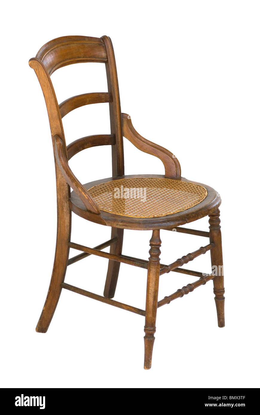 Vintage wood chair with modified arms, ladder-back and cane seat. This is a decorator side chair suitable for bedroom, office, hall. Stock Photo